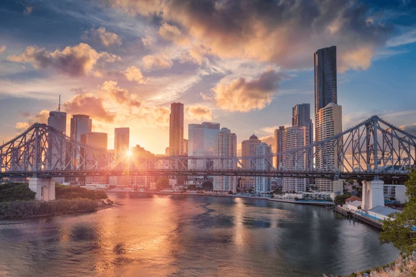 Direct Cremation Brisbane Affordable Transparent Pricing Brisbane city skyline and Story Bridge at sunset.